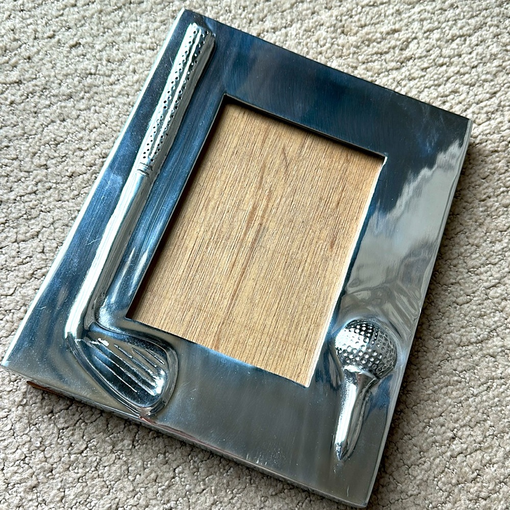 Polished pewter frame by Holland Boone. Golf themed. Holds a 4.5” by 6.5” photo.